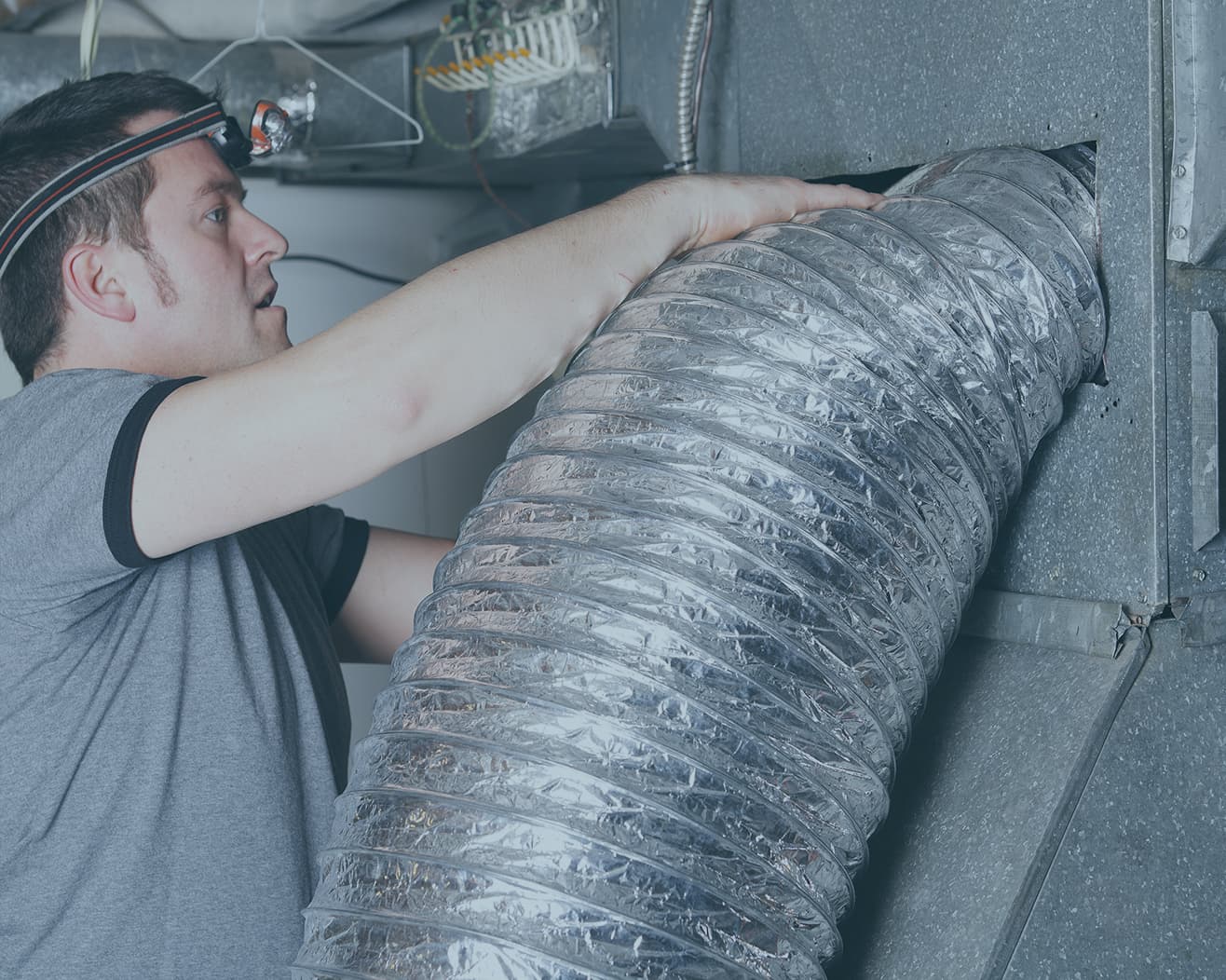 Professional technician inspecting air ducts